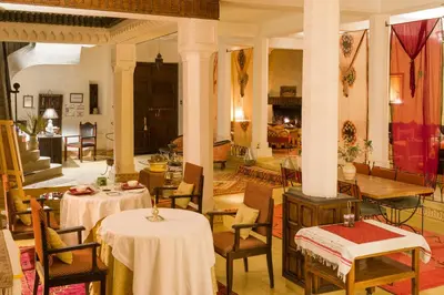 a room with two tables and chairs in a building at Auberge Ksar Jallal in Ksar Oled Cherki