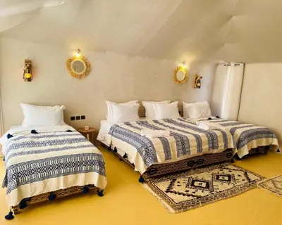 a bedroom with two beds in a room at spirit desert camp in Merzouga