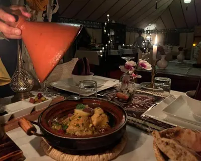 a table with a bowl of food on a table at spirit desert camp in Merzouga