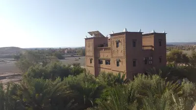 an old building in the middle of the desert at PALM'SKOURA in Skoura