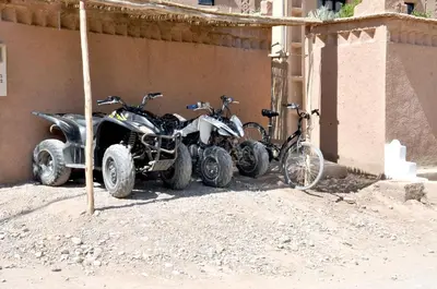 a group of four motorcycles parked next to a building at PALM'SKOURA in Skoura