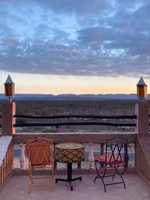 two chairs and a table on a balcony with a view at Kasbah of Peace Draa Valley Zagora in Zagora