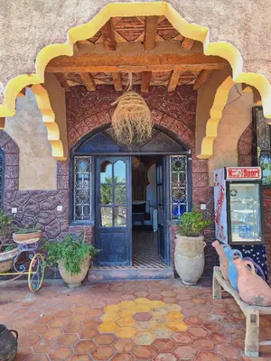 an entry to a house with a blue door at Kasbah of Peace Draa Valley Zagora in Zagora