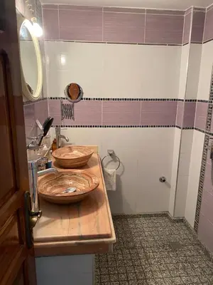 a bathroom with two wooden bowls on top of a sink at Appartement Yasin Meknes in Meknès