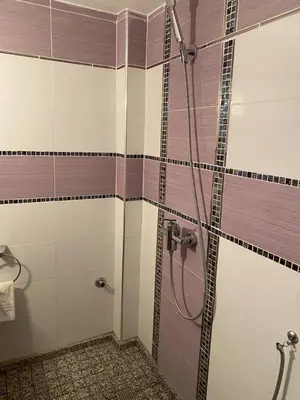 a bathroom with a shower with a glass door at Appartement Yasin Meknes in Meknès