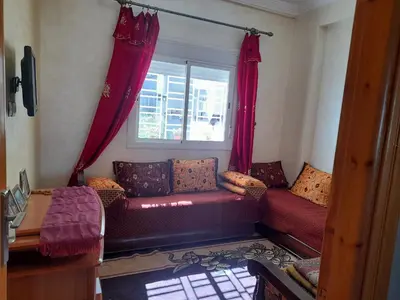 a living room with a couch and a window at Appartement au centre de la ville de Meknès in Meknès