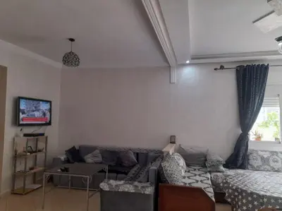 a living room with a couch and a window at Appartement au centre de la ville de Meknès in Meknès