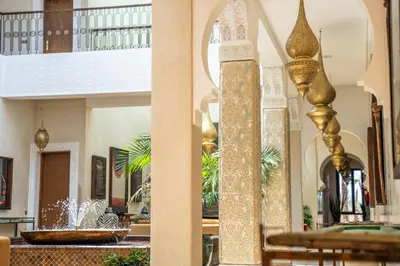 a lobby with a fountain in a building at Al Destino Villa Riad Spa Luxury Marrakech in Marrakech