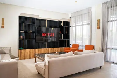 a living room with a couch and a tv at Al Destino Villa Riad Spa Luxury Marrakech in Marrakech