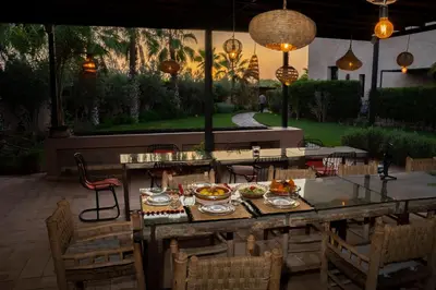 a table with plates of food on a patio at Al Destino Villa Riad Spa Luxury Marrakech in Marrakech