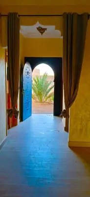 an entrance to a building with a blue doorway at Dar Amrad in Merzouga