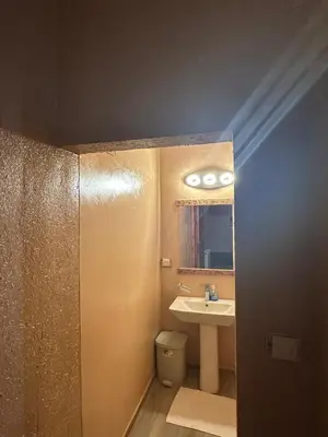 a bathroom with a sink and a toilet and a mirror at DAR AL QANASS IMANE in Midelt