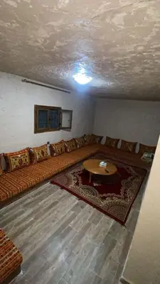 a living room with a couch and a table at DAR AL QANASS IMANE in Midelt