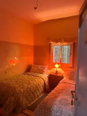 a bedroom with two beds and a window at Hôtel Restaurant ASGAOUR in Amlouggui