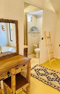 a bathroom with a large mirror and a toilet at Tranquility Luxury Camp in Merzouga
