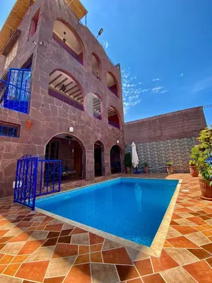 an external view of a house with a swimming pool at DAR EL HACHIMI EL IDRISSI in Ourika