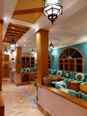 a lobby of a hotel with couches and a chandelier at DAR EL HACHIMI EL IDRISSI in Ourika