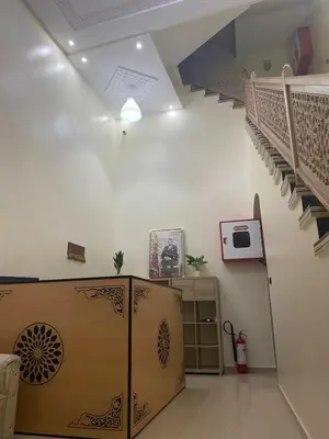 a living room with a staircase and a stair case at Le ruban d’or in Azilal