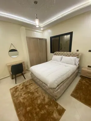 a bedroom with a large white bed and a mirror at Le ruban d’or in Azilal