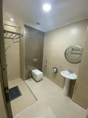 a bathroom with a sink and a shower and a toilet at Le ruban d’or in Azilal