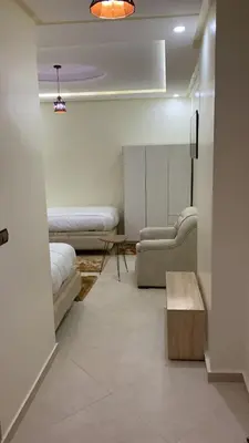a room with two beds and a couch and a table at Le ruban d’or in Azilal