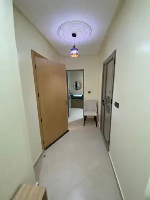 a hallway with a door and a chair at Le ruban d’or in Azilal