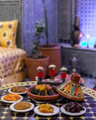 a table topped with plates of food on a table at Riad Tarab Fes in Fès
