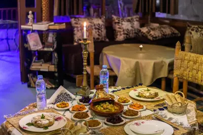 a table with plates of food and a candle at Riad Tarab Fes in Fès