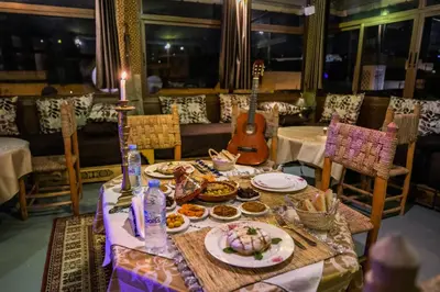 a table with food and a guitar in a restaurant at Riad Tarab Fes in Fès