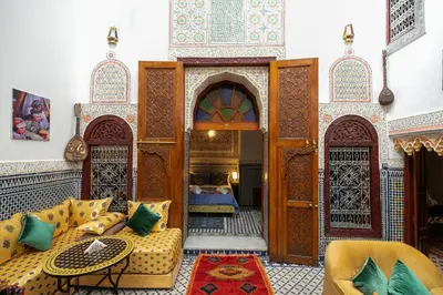 a living room with a couch and a table at Riad Tarab Fes in Fès
