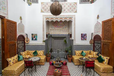 a living room with couches and a fire place at Riad Tarab Fes in Fès
