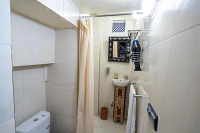 a small bathroom with a sink and a toilet at Riad Tarab Fes in Fès