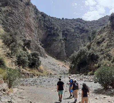 a group of people walking down a mountain trail at TAZEKKA PARC HOTEL in Taza