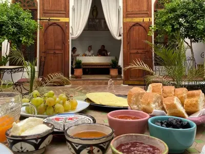 a table topped with lots of different types of food at Dar S'BAH in Fès