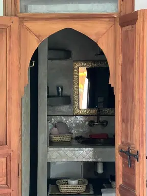 a bathroom with a sink and a mirror in a cabinet at Dar S'BAH in Fès