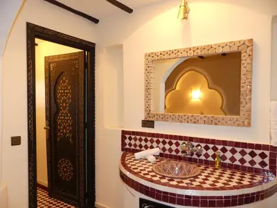 a bathroom with a sink and a mirror at Riad La Luna in Merzouga