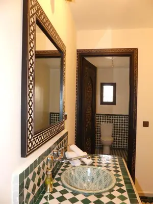 a bathroom with a sink and a mirror at Riad La Luna in Merzouga