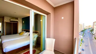 a hotel room with a bed and a glass window at Hôtel Belle Vue et Spa in Meknès