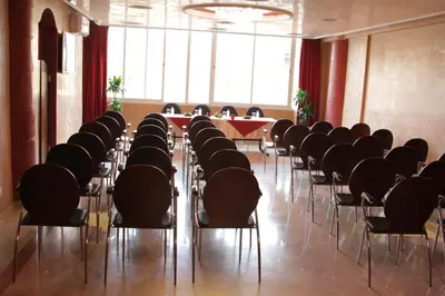 a room with chairs and a table in the middle at Hôtel Belle Vue et Spa in Meknès