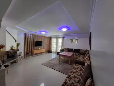 a living room with a couch and a table at Tranquil Oasis in the Heart of Ifrane in Ifrane