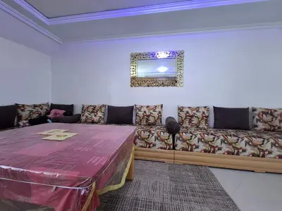 a living room with a table and a couch at Tranquil Oasis in the Heart of Ifrane in Ifrane