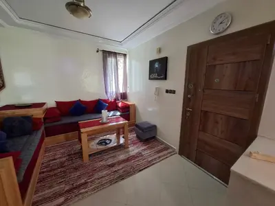 a living room with a couch and a wooden door at Tranquil Oasis in the Heart of Ifrane in Ifrane