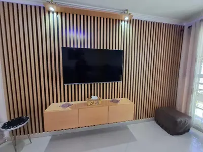 a living room with a television on a striped wall at Tranquil Oasis in the Heart of Ifrane in Ifrane