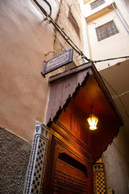 a doorway to a building with a sign above it at Riad Baba in Fès