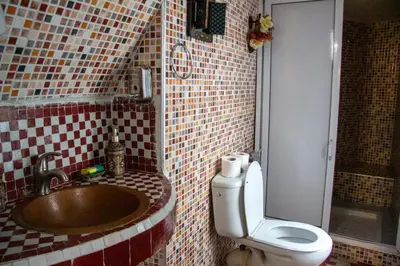 a bathroom with a sink and a toilet in it at Riad Baba in Fès