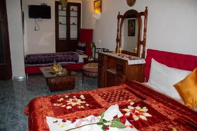a hotel room with a bed and a room with at Riad Baba in Fès