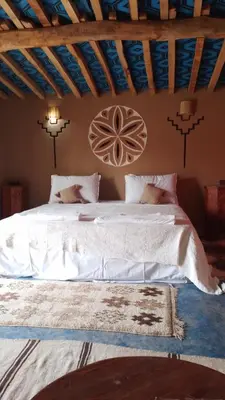 a bedroom with a large bed in a room at Sahara Camp Light in Mhamid