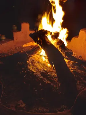 a fire is burning in a brick oven at Sahara Camp Light in Mhamid