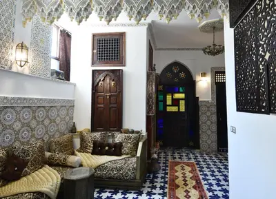 a living room with a couch and a door at Dar Aya Fes in Fès