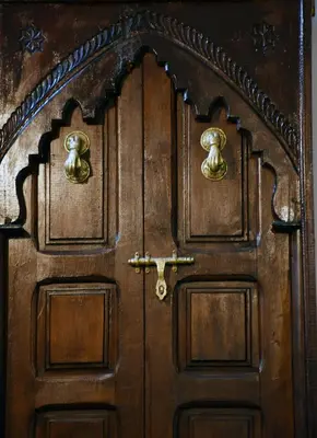 a wooden door with gold knockers on it at Dar Aya Fes in Fès